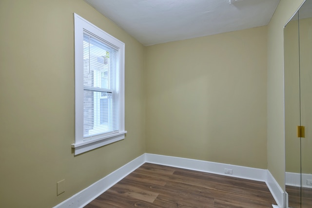 unfurnished room featuring dark hardwood / wood-style floors