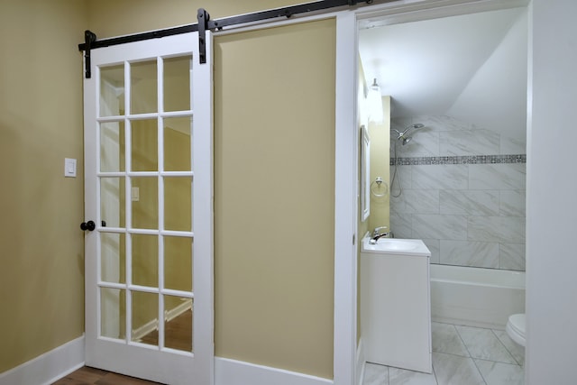 full bathroom featuring vanity, toilet, and tiled shower / bath