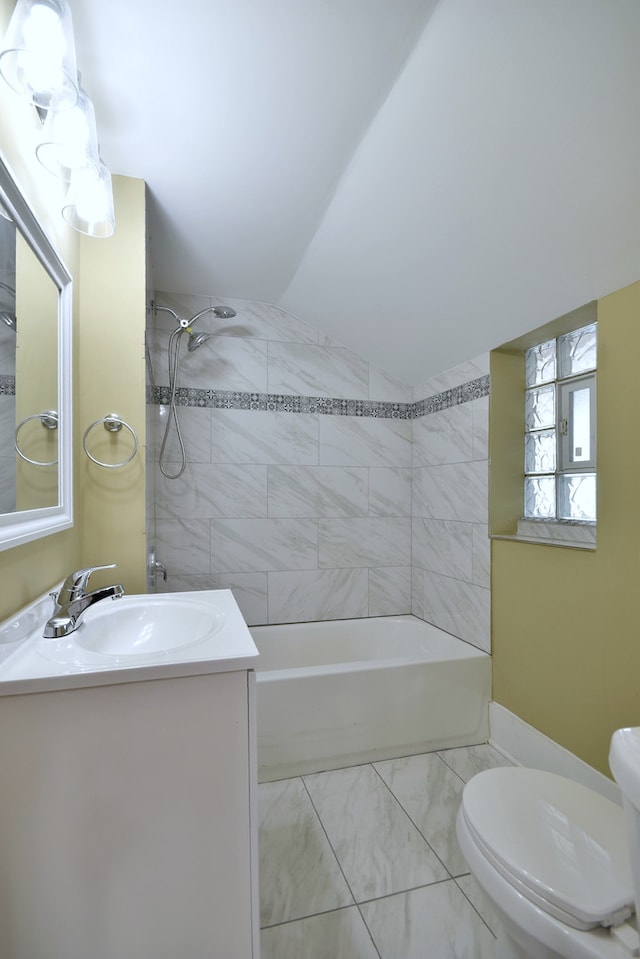 full bathroom featuring toilet, tiled shower / bath combo, and vanity