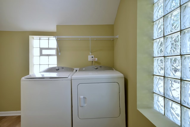 laundry room with washer and clothes dryer and hardwood / wood-style flooring