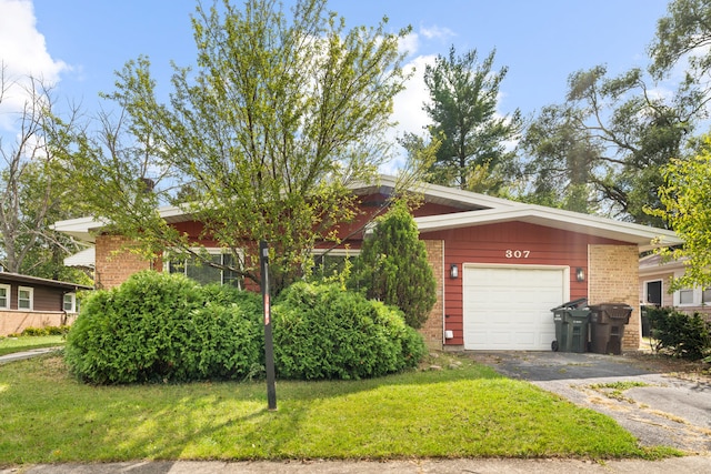 view of front of property with a garage and a front lawn