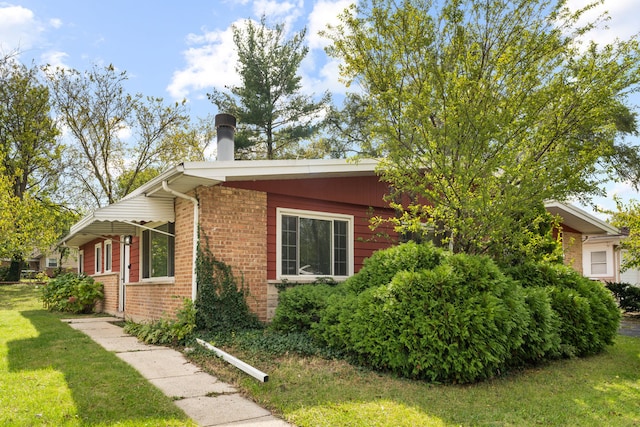 view of side of property with a lawn