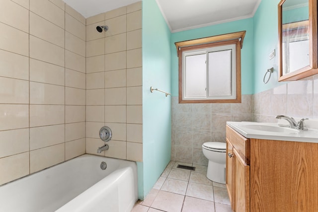 full bathroom featuring vanity, tile walls, tiled shower / bath combo, and toilet