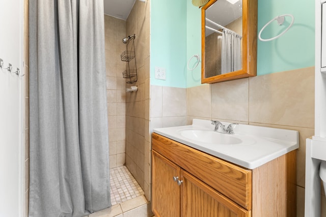 bathroom with walk in shower, tile walls, vanity, and tile patterned floors