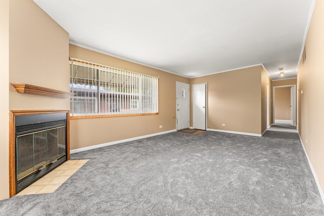 unfurnished living room featuring ornamental molding, a tiled fireplace, and light colored carpet