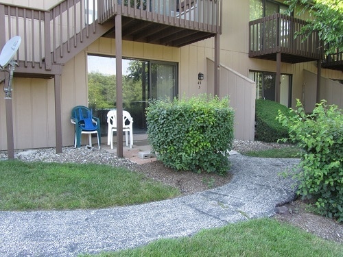 view of exterior entry featuring a balcony and a patio