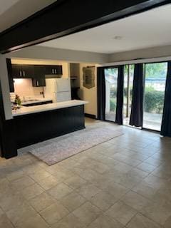 interior space featuring kitchen peninsula and white refrigerator