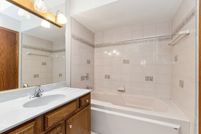 bathroom featuring vanity and tiled shower / bath