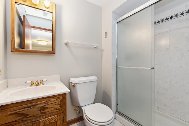 bathroom featuring vanity, an enclosed shower, and toilet