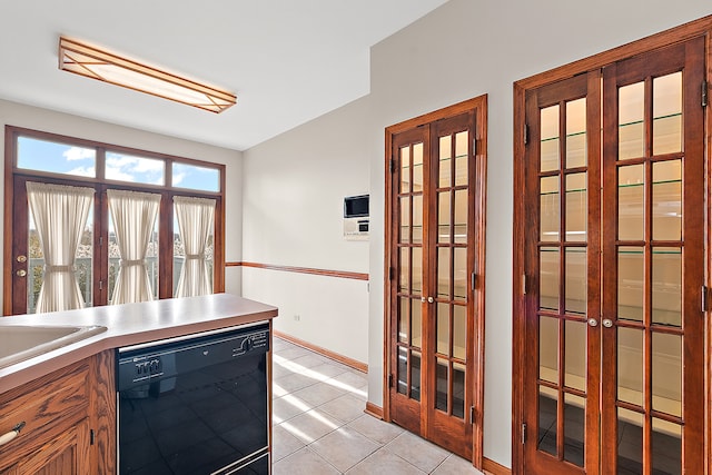 kitchen featuring dishwasher, light tile patterned floors, and french doors