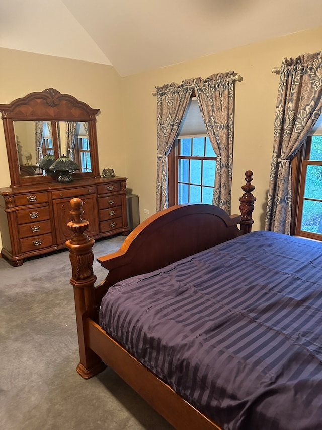 carpeted bedroom featuring vaulted ceiling