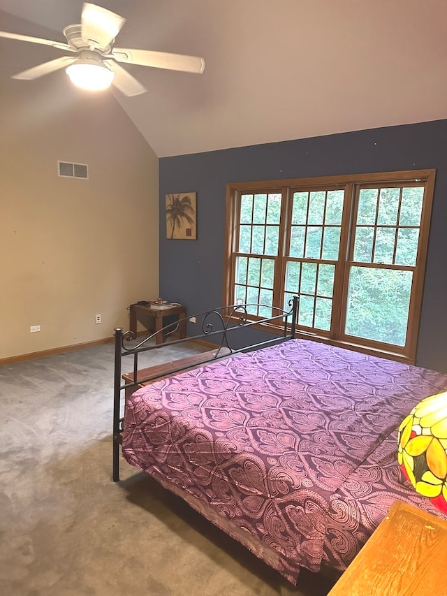 carpeted bedroom featuring ceiling fan, vaulted ceiling, and multiple windows