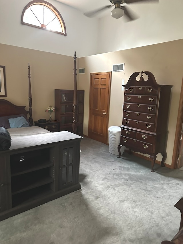 carpeted bedroom with high vaulted ceiling and ceiling fan