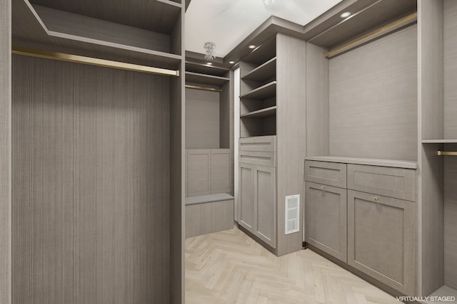 walk in closet featuring light parquet flooring