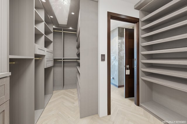 walk in closet featuring light parquet flooring