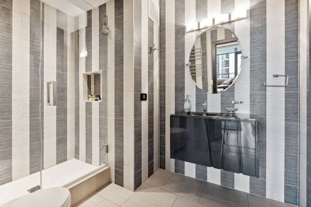 bathroom with vanity, toilet, an enclosed shower, and tile patterned floors