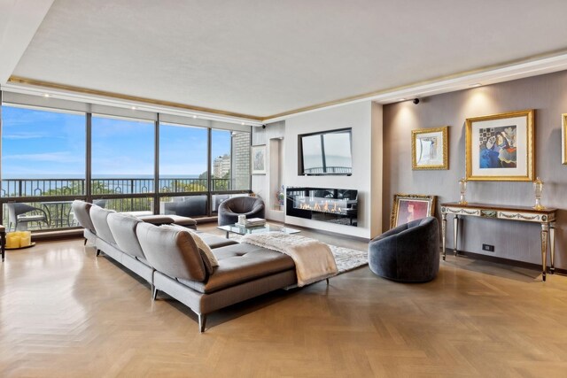 living room featuring light parquet flooring, expansive windows, and a wealth of natural light