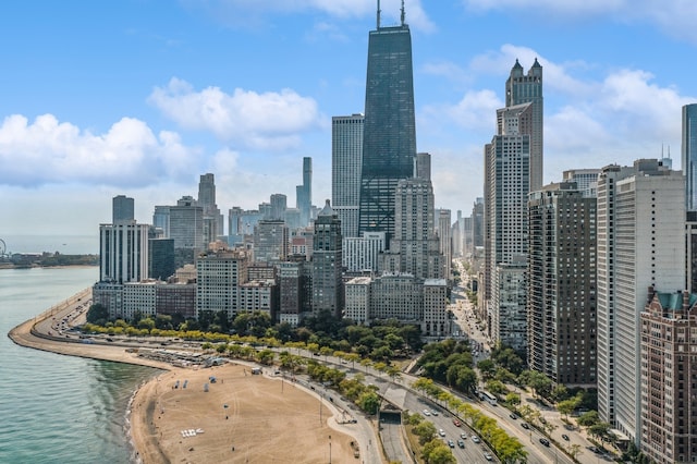 view of city with a beach view and a water view