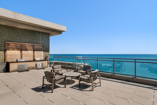 view of patio with a water view