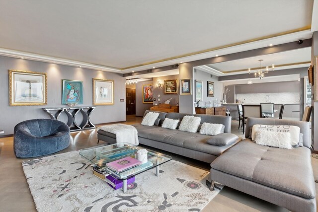 living room featuring ornamental molding and an inviting chandelier