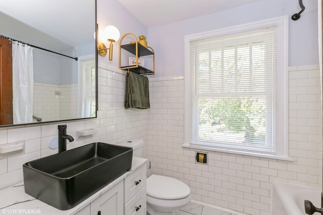 bathroom featuring tile walls, tile patterned flooring, vanity, and toilet