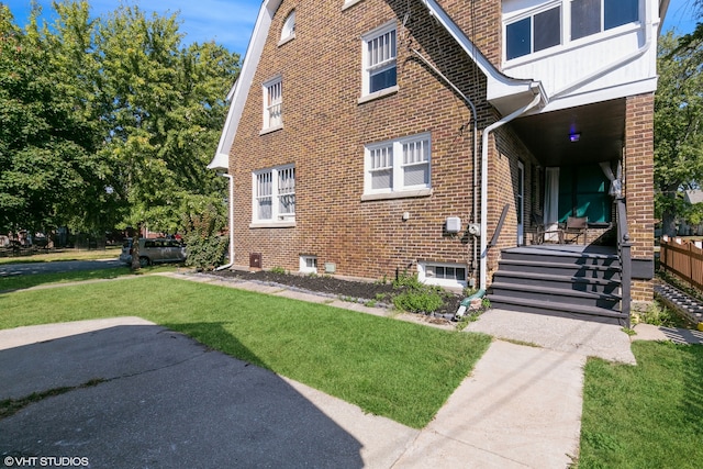 view of side of property featuring a yard