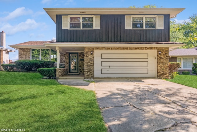 view of front of home featuring a garage and a front lawn