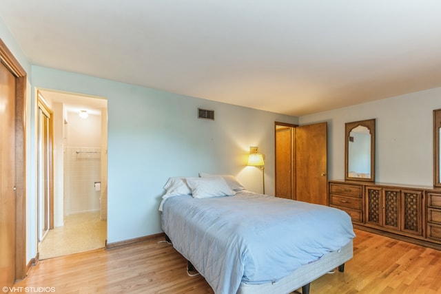 bedroom with a closet and light hardwood / wood-style floors