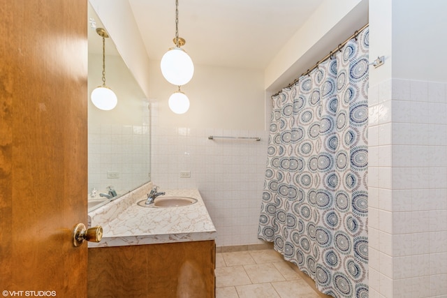 bathroom featuring vanity, tile walls, and tile patterned flooring