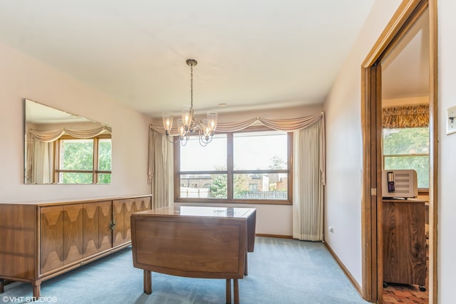 dining room with a chandelier, carpet, and a healthy amount of sunlight