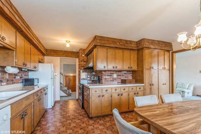 kitchen featuring hanging light fixtures, a chandelier, white dishwasher, sink, and stainless steel range with electric cooktop