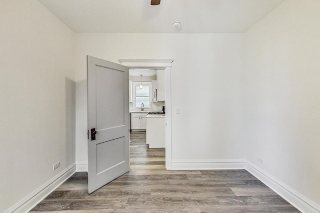 spare room with ceiling fan and hardwood / wood-style floors