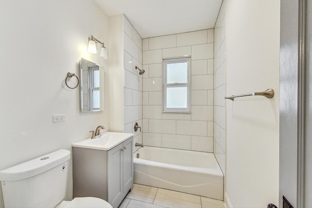 full bathroom featuring vanity, tiled shower / bath combo, toilet, and tile patterned flooring