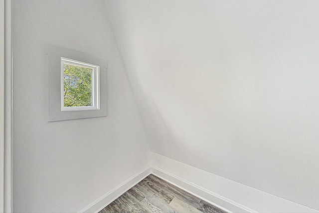 empty room featuring vaulted ceiling and hardwood / wood-style floors