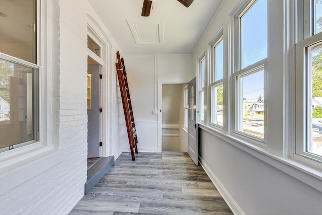 interior space featuring light hardwood / wood-style flooring and brick wall