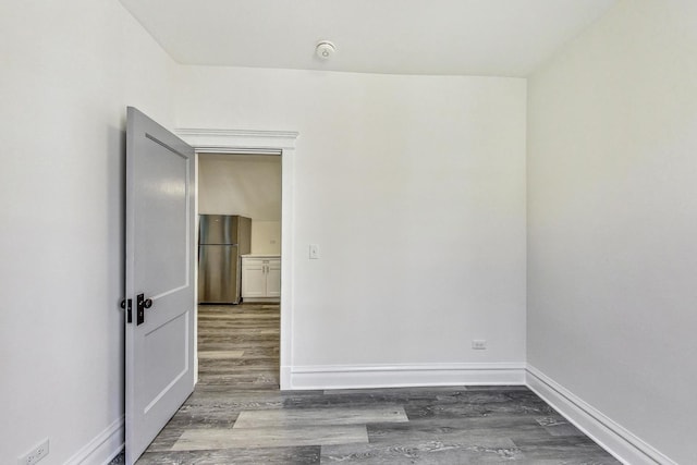 unfurnished room with dark wood-type flooring