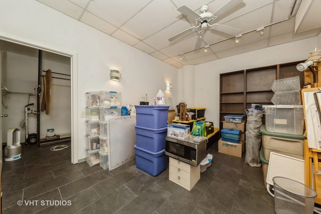 interior space featuring ceiling fan and dark tile patterned floors