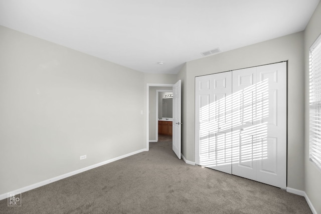 unfurnished bedroom featuring carpet floors and a closet