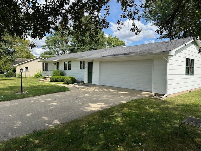 ranch-style house featuring a garage and a front lawn