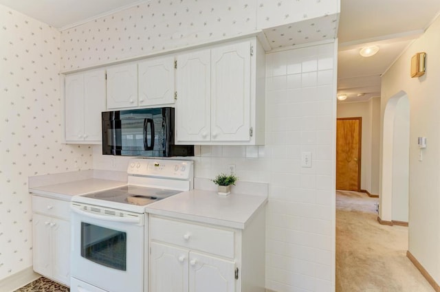 kitchen featuring crown molding, white electric range, light colored carpet, and white cabinetry