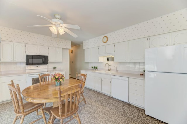 kitchen featuring white appliances, sink, ceiling fan, and white cabinets