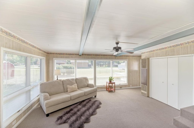 sunroom with beam ceiling, ceiling fan, and plenty of natural light