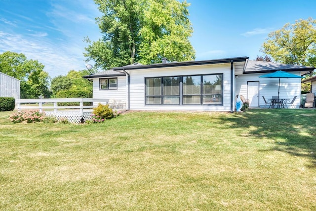 back of house with a lawn