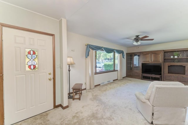 unfurnished living room featuring ceiling fan and light colored carpet