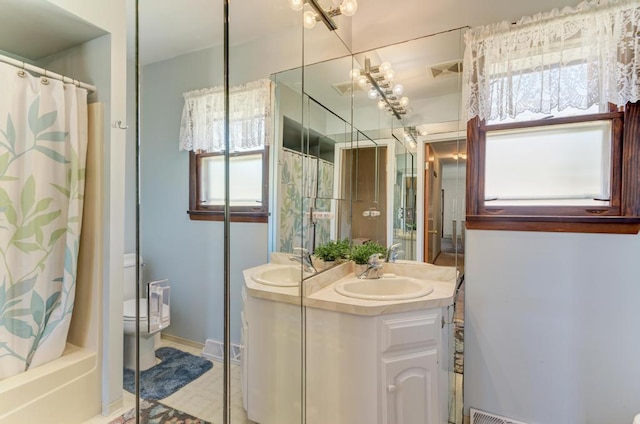 full bathroom with vanity, toilet, and shower / tub combo with curtain