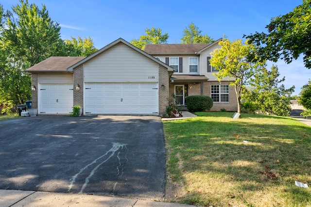 view of property with a garage and a front yard