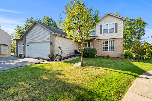 view of property with a front yard and a garage