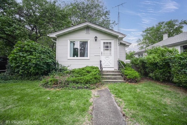 bungalow-style house with a front lawn