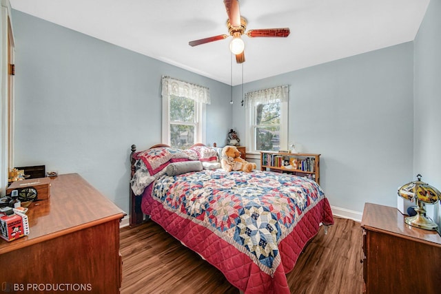 bedroom with ceiling fan, baseboards, and wood finished floors