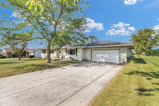 ranch-style house featuring a garage and a front lawn